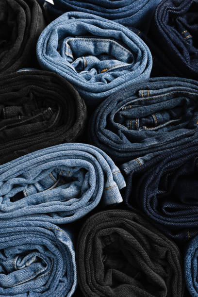 istock Folded jeans in various shades of blue and black on a white background. Denim background. Jeansy denim 2157408672