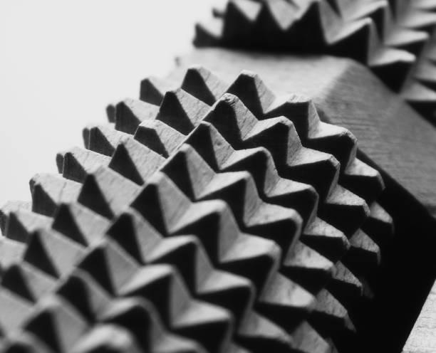 A row of interlocking gears trail behind a forward pointing arrow.