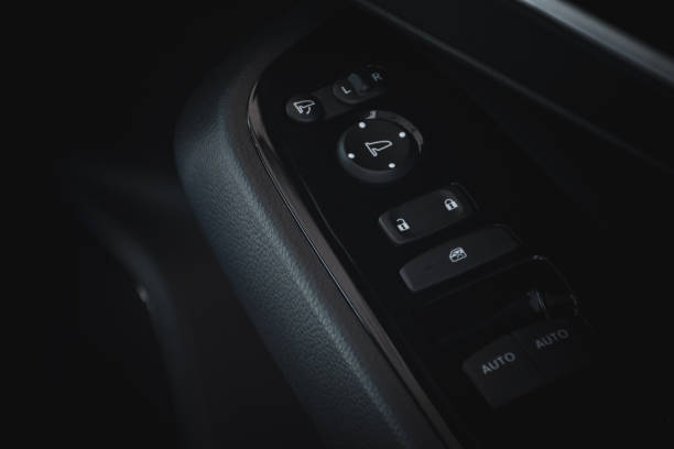 istock Close up of modern car door control panel button with lock button and automatic window adjustment in dark black tone. Interior decoration of modern cars in 2024. 2157408734