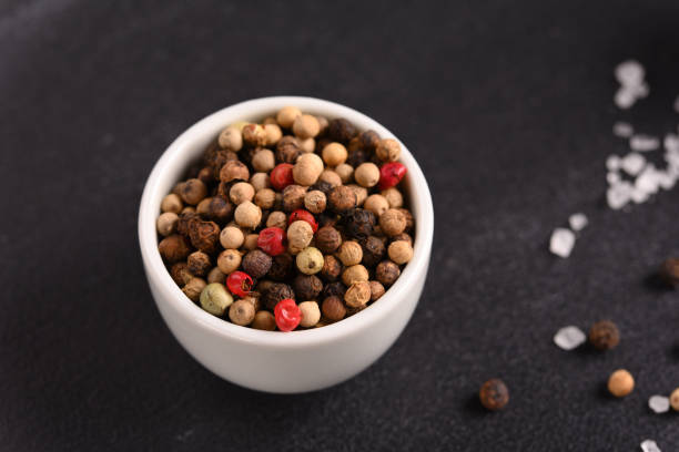 istock Colorful pepper and salt in small white bowls on a dark background. 2157409687