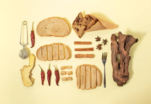 Creatively arranged bread, wood, chili pepper and spices. Flat lay pattern