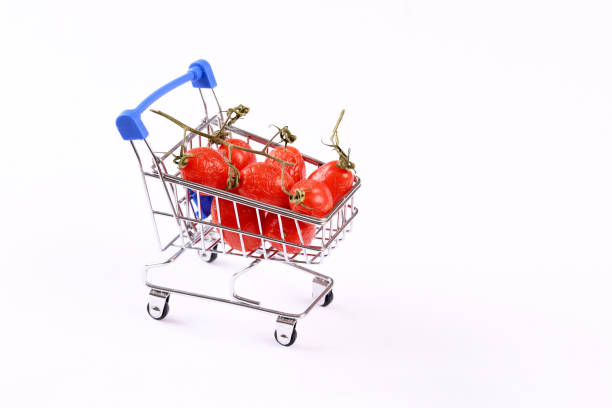 Not fresh shrivelled tomatoes in shopping cart.
