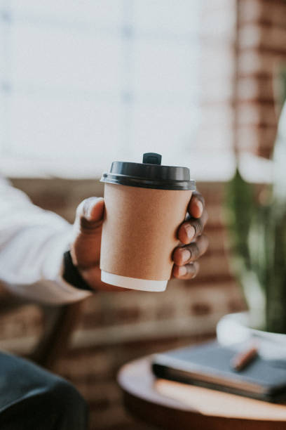 istock Man holding a takeaway coffee cup 2157413291