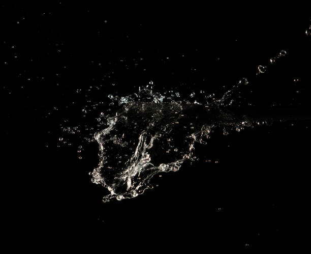 istock Mass water to object make curve fly explosion in mid air motion. Black background isolated. Mass Water splash on object to create shape form fluttering in curve 2157413640