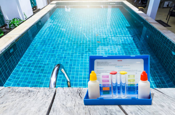 istock Swimming pool water tester test kit over on swimming pool edge 2157414033