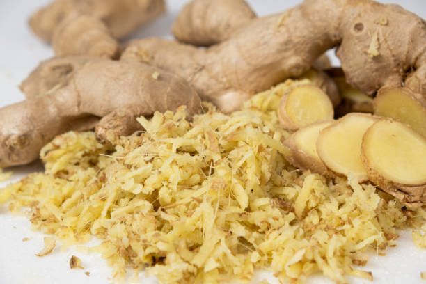 istock Pieces of finely grated fresh ginger root on kitchen board 2157417653