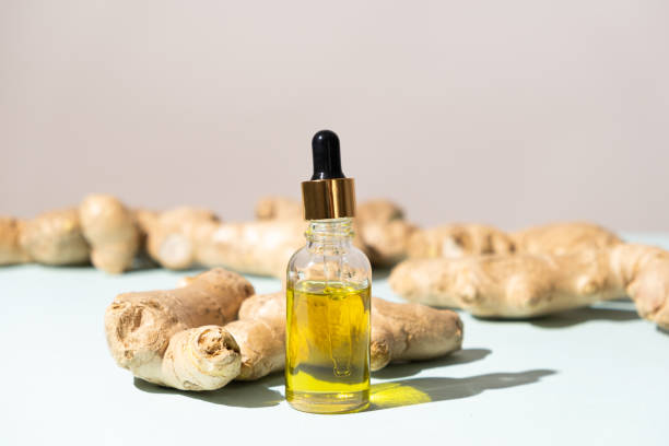 istock Natural ginger oil in glass bottle among ginger root 2157417655