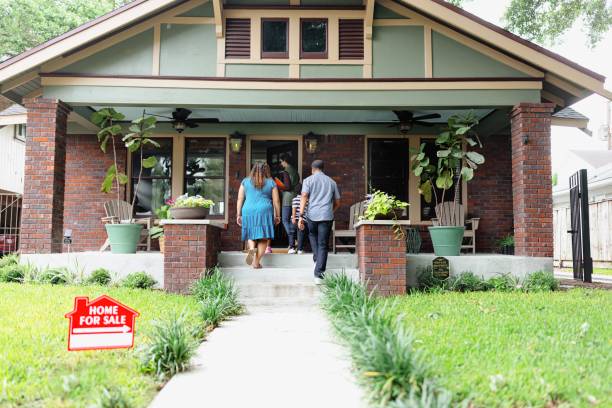 istock Clients entering with a real estate agent in an open house 2157419757