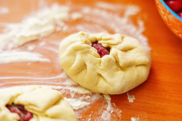 istock Uncooked Belyash, traditional meat-filled pastry, dusted with flour on a kitchen table 2157420024
