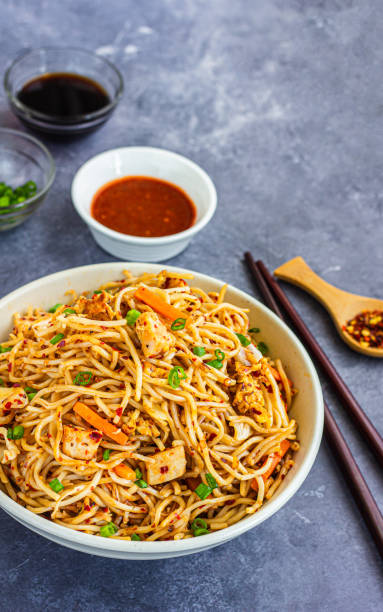 Chicken Chow Mein with Tomato Ketchup and Chilli Flakes High Angle Photo
