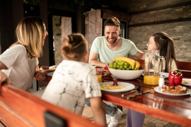 istock Family enjoys a conversation while eating on the terrace 2157422263
