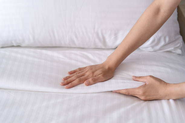 istock Close-up of hands setup bed sheet. House keeping. 2157424212