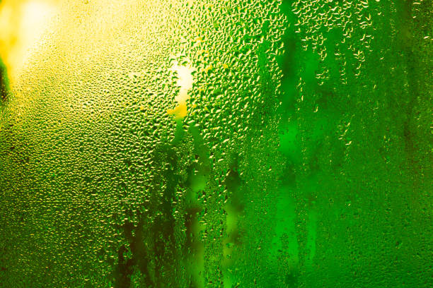 istock wet glass with water drops. green background. 2157425913