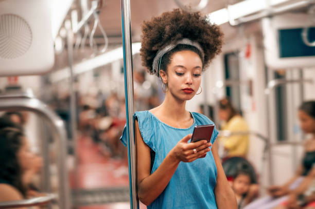 istock Ethnic woman using smartphone in subway 2157426544