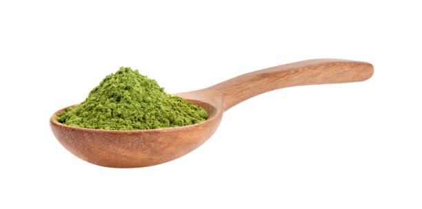 istock matcha green tea powder in wood spoon on white background 2157428402