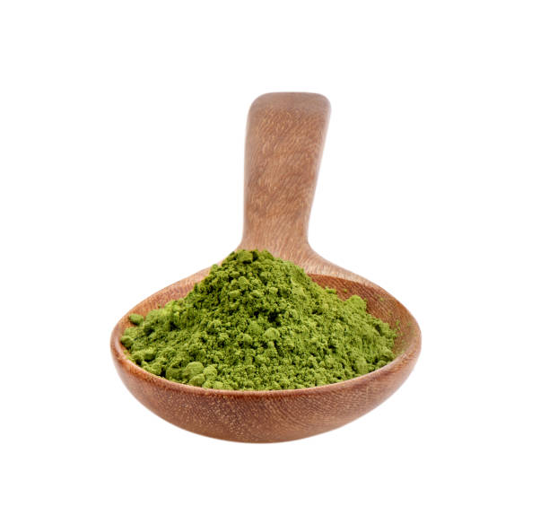 istock matcha green tea powder in wood spoon on white background 2157428418