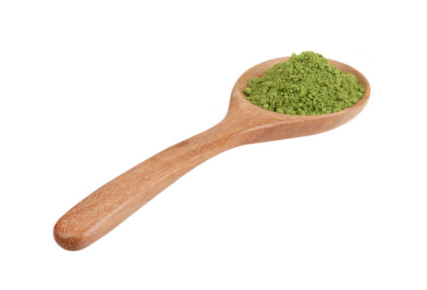 istock matcha green tea powder in wood spoon on white background 2157428576