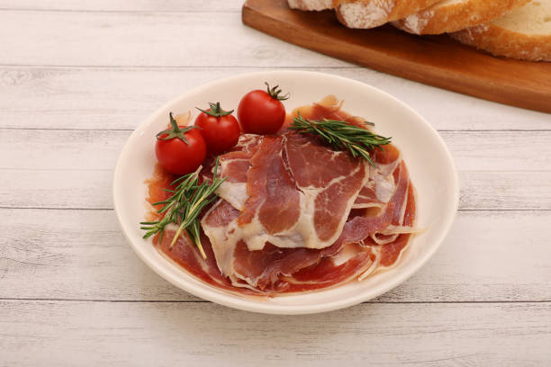 istock Cured ham and mini tomatoes on a plate. 2157428988