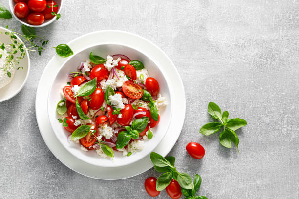 istock Salad of tomato, ricotta cheese and basil, top view 2157429961