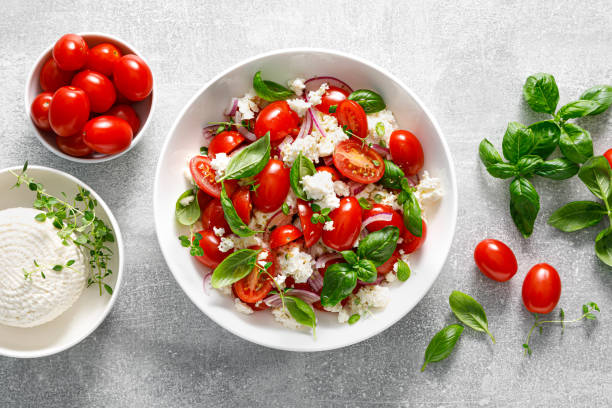 istock Salad of tomato, ricotta cheese and basil, top view 2157429964