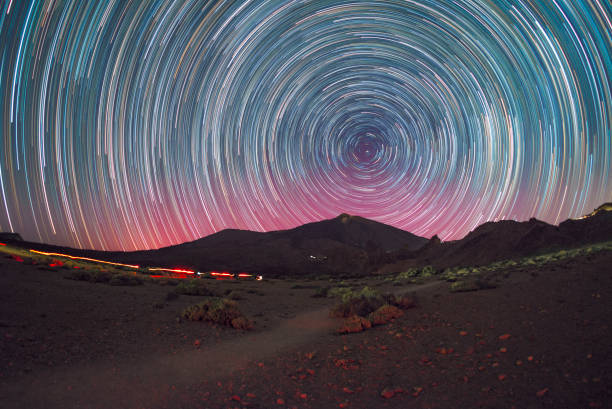A stunning photo capturing the night sky with swirling stars above the Teide volcano in Tenerife. The clear night reveals the beauty of the stars against the volcanic landscape.