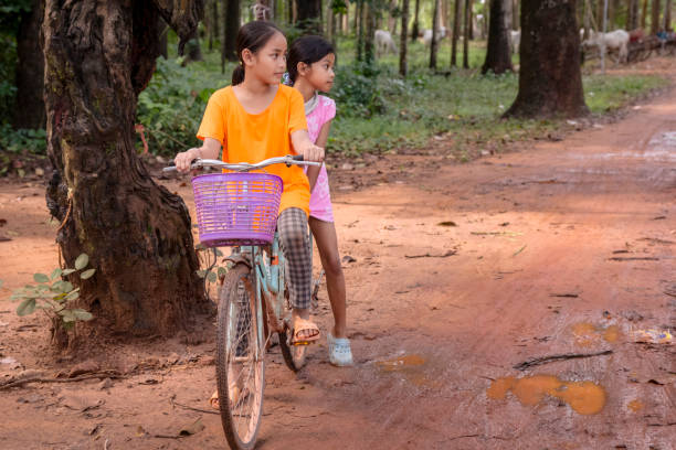 istock Cambodian girls riding a bicycle, Cambodia 2157432350