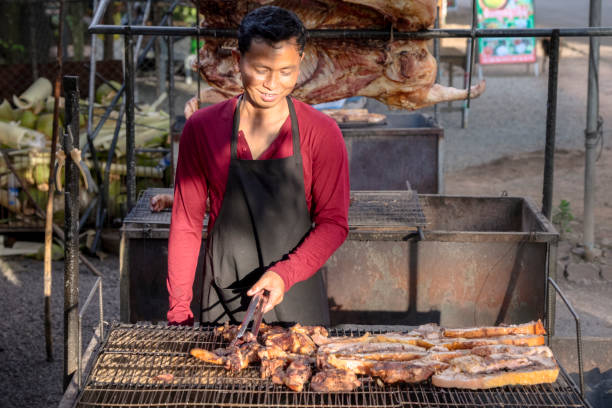Cambodian man selling snacks, Siem Reap, Cambodia Cambodian man selling fresh fresh snacks on a local market, Siem Reap, Cambodia cambodia food stock pictures, royalty-free photos & images