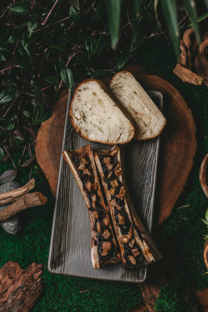 istock Top view of delectable bone marrow dish stuffed with bread and filling on plate 2157432545
