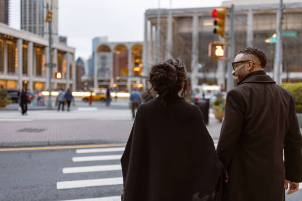 istock Elegantly Dressed Couple Walking to NYC Theatre 2157433403