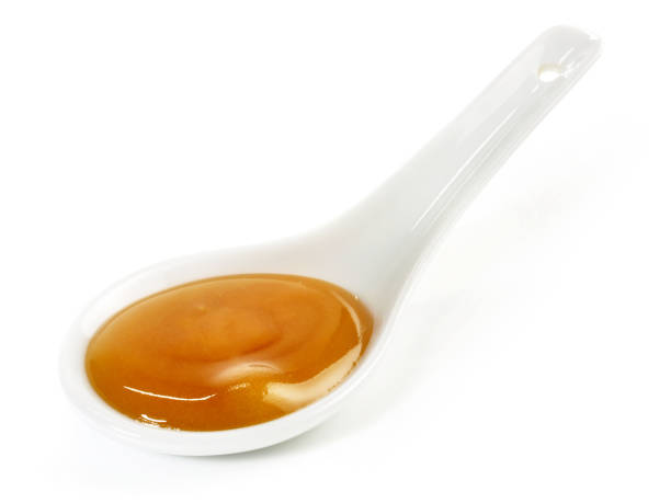 istock Manuka Honey in a Spoon isolated on white Background 2157433893