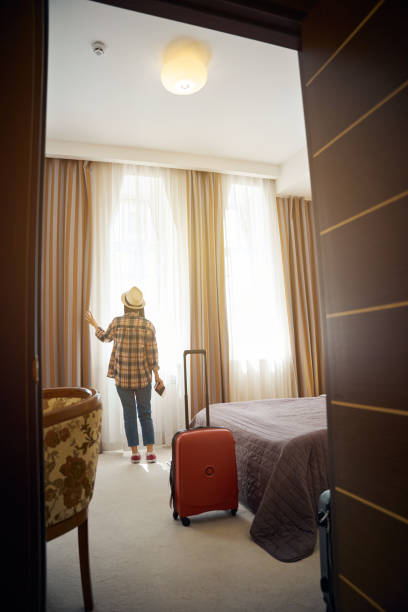 istock Tourist contemplating cityscape on arrival at her suite 2157434428