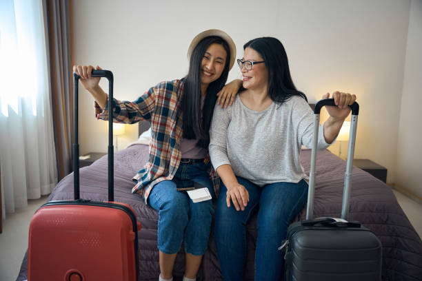 istock Two contented travelers seated in hotel room on arrival 2157434474