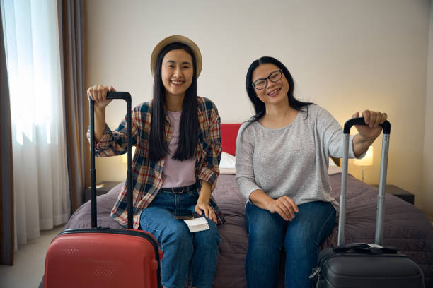 istock Contented Asian tourists sitting in suite upon arrival 2157434483