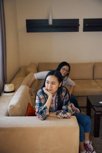 istock Upset daughter ignoring her irritated mother after home conflict 2157434515