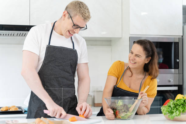 istock A man and woman are in a kitchen, preparing a salad 2157436145