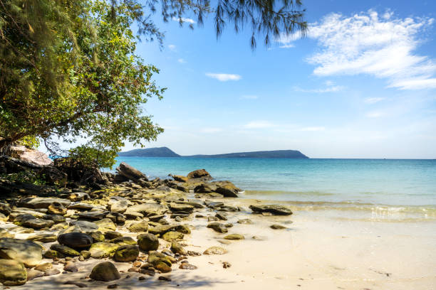 Beautiful beach view on Koh Rong Island, Sihanoukville Province, Cambodia. Serene ocean, clear sky, and lush greenery creating a tranquil atmosphere.