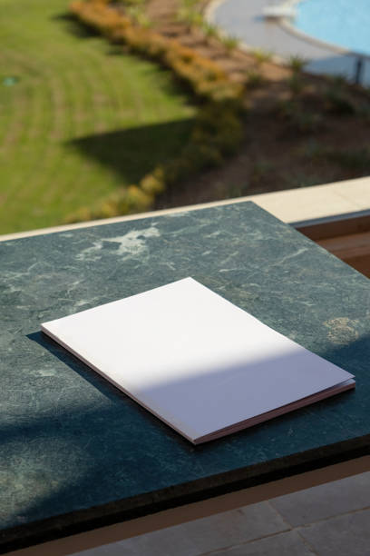istock blank magazine mockup on green marble stone coffee table , shadow overlay 2157439045