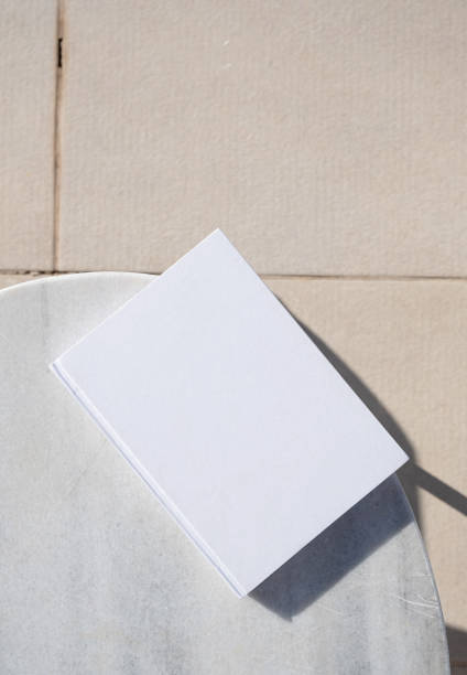istock blank book for mockup design on marble table by the swimming pool 2157439295