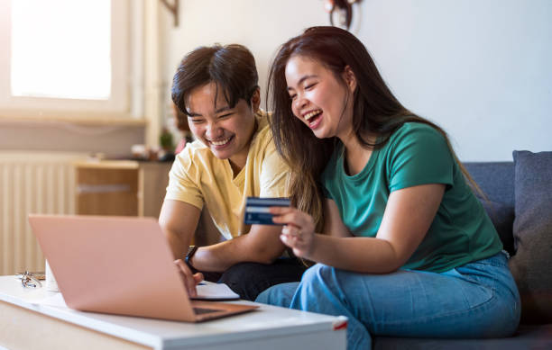 istock Happy young couple using laptop together at home 2157440592