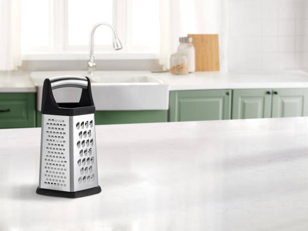 istock Metal food grater on a marble countertop in a kitchen 2157442081