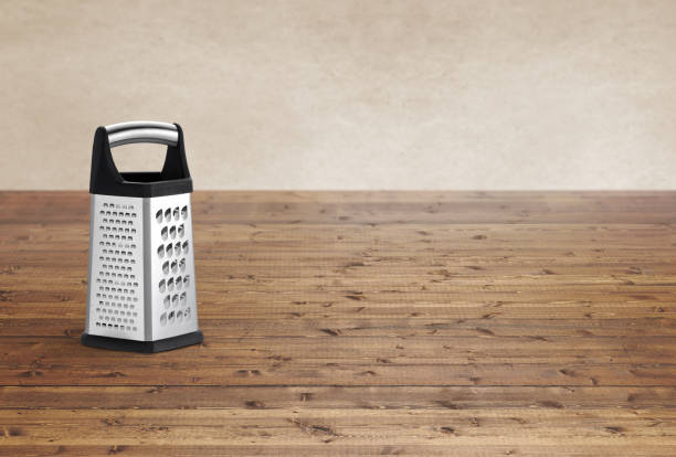 Metal food grater on a wood background