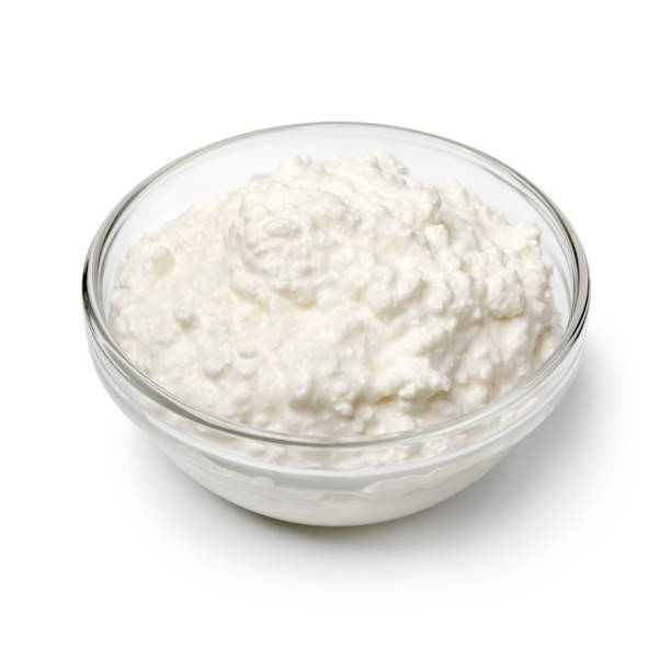 Glass bowl with Cottage cheese on white background close up