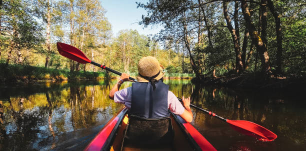 istock Back Rear View strong caucasian woman rowing Kayaking In Beautiful Lithuania countryside river - Zemeina. Action Camera POV Of Girl Paddling On canoe. Active holidays fun outdoors 2157444802