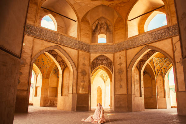 istock Kashan, Iran - 29th may, 2022: female Tourist wear special robe visit explore beautiful Agha Bozorg Mosque in sunny day 2157444863