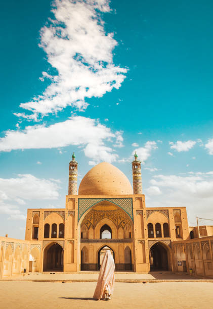 istock Kashan, Iran - 29th may, 2022: female Tourist wear special robe visit explore beautiful Agha Bozorg Mosque in sunny day 2157444868