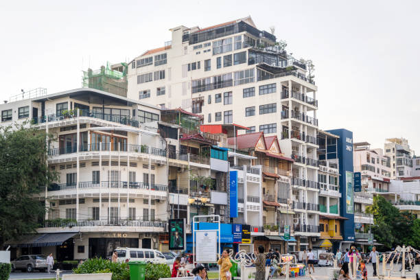 A bustling street in Phnom Penh, Cambodia featuring varied architecture and daily urban activities on March 1st, 2023.