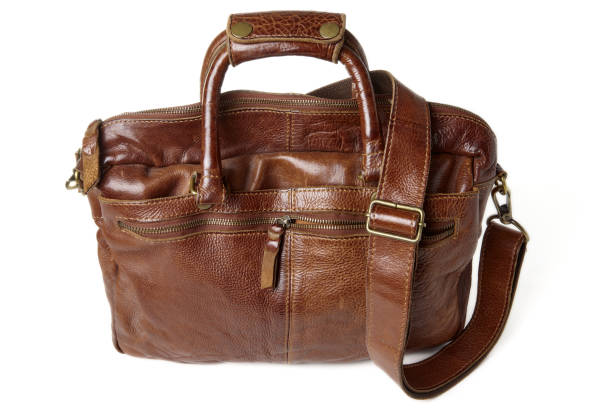 Vintage rough cowhide leather briefcase isolated on a white background. Brown laptop and document bag Vintage rough cowhide leather briefcase isolated on a white background. Brown laptop and document bag. leather medical bag stock pictures, royalty-free photos & images