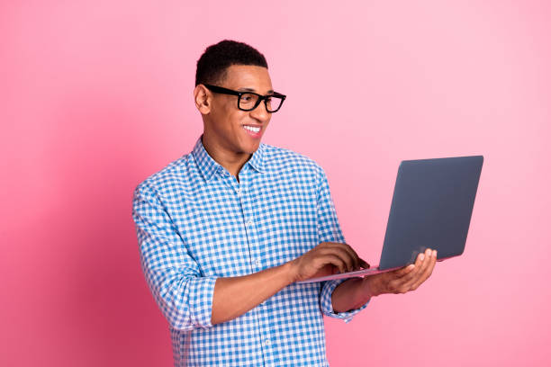 istock Photo of handsome confident guy wear plaid shirt typing modern gadget emtpy space isolated pink color background 2157446730