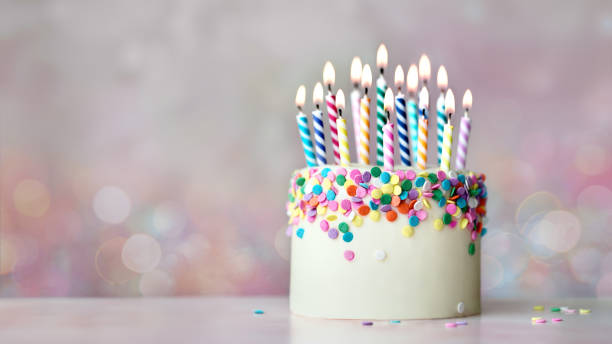 istock Colorful celebration birthday cake with colorful birthday candles and sugar sprinkles 2157446838