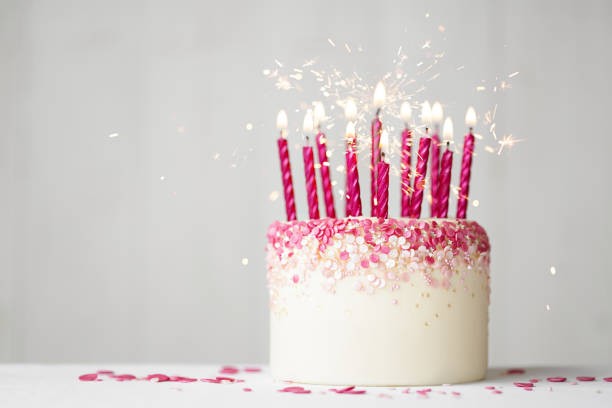 istock Pink celebration birthday cake with pink birthday candles and sparklers 2157446856